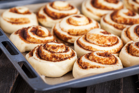 Raw cinnamon rolls. Preparation process - unbaked dough, waiting befor bakingの写真素材