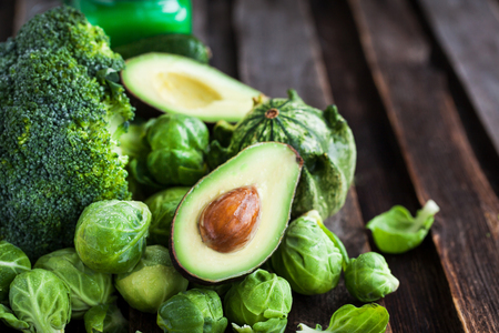 Assortment of fresh green vegetables on wooden tableの写真素材