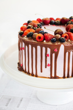 Delicious homemade cake decorated with chocolate and fresh berriesの写真素材