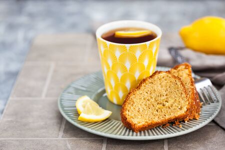 Lemon cake slices and cup of hot black tea