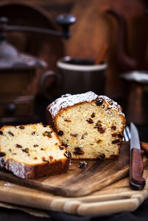 Delicious homemade cottage cheese and raisins loaf cake on dark rustic wooden backgroundの写真素材