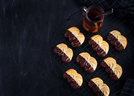 Homemade chocolate dipped shortbread cookies on dark backgroundの写真素材