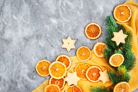 Top view of dried oranges on Holiday Christmas background, gray and yellowの写真素材