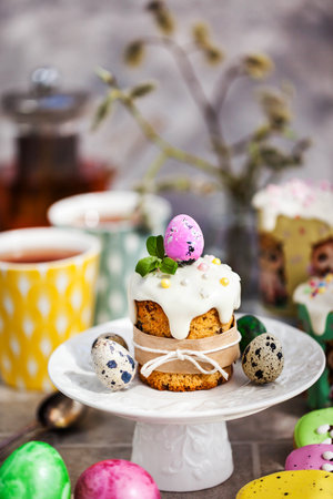 Sweet Easter bread, panettone or kulich and colorful painted eggs, Holiday spring concept