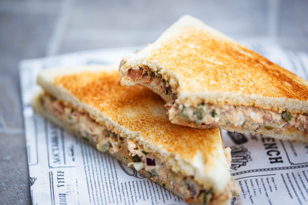 Delicious tuna salad sandwich and papr cup of coffeewith eggsの写真素材