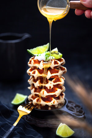 Delicious healthy gluten free coconut wafers, served with honey, kiwi, lime and creamの写真素材