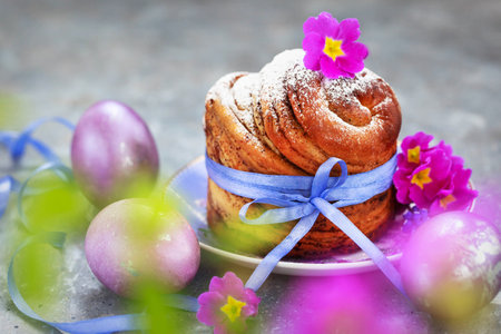Sweet Easter bread, panettone or cruffin and colorful painted eggs, Holiday spring conceptの写真素材