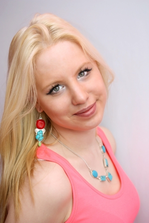 Closeup portrait of pretty young girl on a light backgroundの写真素材