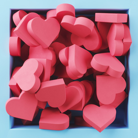 Lots of pink hearts in a square blue box. Background.の写真素材