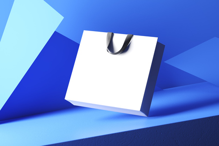 White bag on a blue geometric background of triangles.の写真素材
