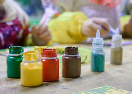 Colorful paints on the background of drawing childrenの写真素材