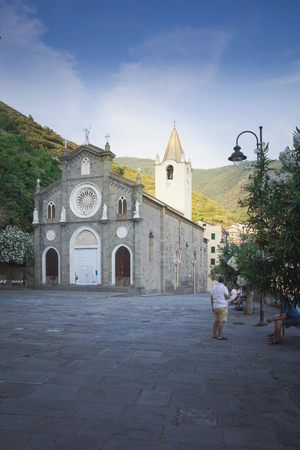 Church of San Giovanni Battista in Riomaggiore, Cinque Terre, Italy, 06 august 2018: Square in front of the Church of St. Giovanni Battistaの写真素材