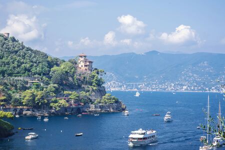 Portofino landscape, view from top to boats on water, colorful houses and villas, slopes of the mountains in Portofino town of Italy, Liguria.の写真素材