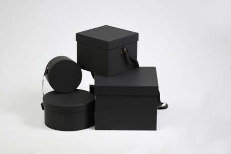 Composition of black empty template square gift cardboard packaging boxes with closed lids