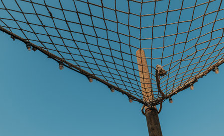 Decorative rope netting and string lights outdoor with blue sky on the background