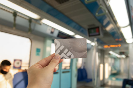 Dubai, UAE - October 6, 2020: Holding a Dubai metro card inside a modern metro train cabin