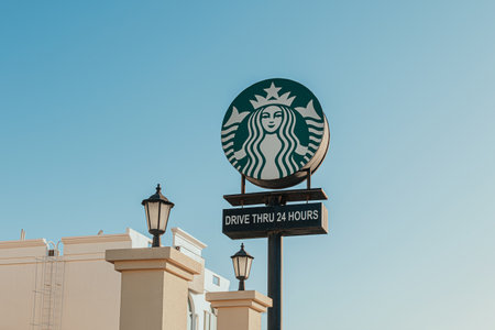 Dubai, UAE - February 14 2020: Starbucks drive-thru sign with 24-hour service under clear blue sky on Jumeirah Roadのeditorial素材