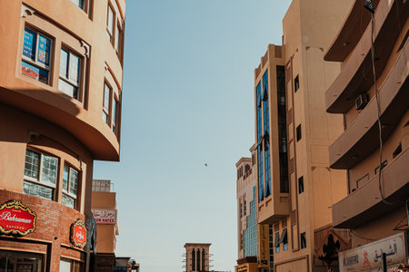 Dubai, UAE - January 6, 2020: Narrow street in Deira district with modern and traditional buildingsのeditorial素材