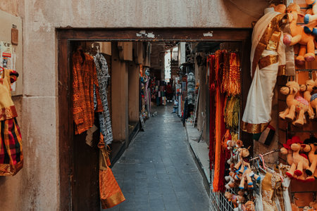 Dubai, UAE - January 6, 2020: Vibrant textiles and toys displayed in a narrow alley at Grand Souq, Bur Dubaiのeditorial素材