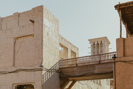 Traditional wind tower structure and stone bridge in Al Seef Old Dubai districtの写真素材