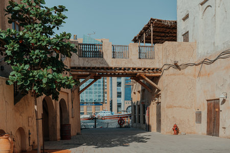 Dubai, UAE - January 6, 2020: Traditional stone buildings with greenery in Al Seef Old Dubai districtのeditorial素材