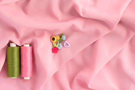 Sewing accessories and fabric on a white background. Sewing threads, pins, fabric, buttons. Top view, flat lay. Spring colorの写真素材