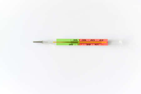 Pharmaceutical medical thermometer isolated at the white background, top view with large copy space...