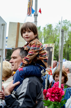 Kerch, Russia 05 09 2019: Parade Victory Day. People participate in the patriotic action Immortal Regiment. They are holding portraits of people who participated in the Great Patriotic War.のeditorial素材