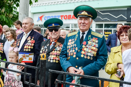Kerch, Russia 05 09 2019: Parade Victory Day. People participate in the patriotic action Immortal Regiment. They are holding portraits of people who participated in the Great Patriotic War.のeditorial素材