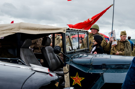 Kerch, Russia 05 09 2019: Parade Victory Day. People participate in the patriotic action Immortal Regiment. They are holding portraits of people who participated in the Great Patriotic War.のeditorial素材