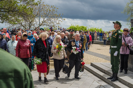 Kerch, Russia 05 09 2019: Parade Victory Day. People participate in the patriotic action Immortal Regiment. They are holding portraits of people who participated in the Great Patriotic War.のeditorial素材
