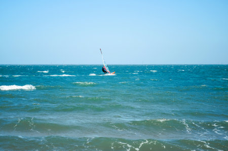 Kerch, Russia - 18 August 2020: Kite surfing on the blue sea in the background of blue sky at summer time. Kiteboarding. Fun in the ocean. Extreme Sport, surfing manのeditorial素材