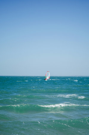 Kerch, Russia - 18 August 2020: Kite surfing on the blue sea in the background of blue sky at summer time. Kiteboarding. Fun in the ocean. Extreme Sport, surfing manのeditorial素材