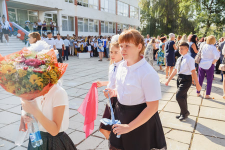 Kerch Russia September 1, 2020 - children go to school, first bell, smart students, children with schoolbags and in school uniforms, teachers and parents in front of school, holiday of knowledgeのeditorial素材