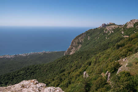 High rocks Ai-Petri of Crimean mountains. Black sea coast and blue sky with clouds. Russia. pine...
