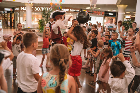 Happy kids celebrating party in the mall, in a shopping center, performance with artists, photographerのeditorial素材