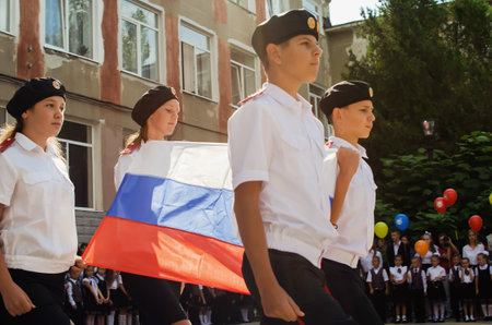 Kerch Russia - September 1, 2020 - children go to school, first bell, childrens in school uniforms, teachers and parents in the background near the schoolのeditorial素材