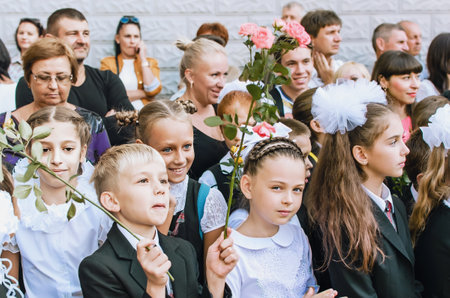 Kerch Russia - September 1, 2020 - children go to school, first bell, childrens in school uniforms, teachers and parents in the background near the schoolのeditorial素材