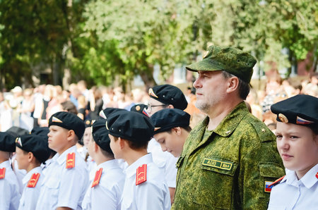 Kerch Russia - September 1, 2020 - children go to school, first bell, childrens in school uniforms, teachers and parents in the background near the schoolのeditorial素材