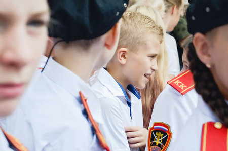 Kerch Russia - September 1, 2020 - children go to school, first bell, childrens in school uniforms, teachers and parents in the background near the schoolのeditorial素材