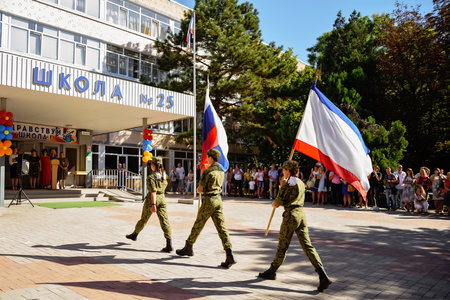 Kerch Russia - September 1, 2020 - children go to school, first bell, childrens in school uniforms, teachers and parents in the background near the schoolのeditorial素材