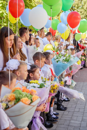 Kerch Russia - September 1, 2020 - children go to school, first bell, childrens in school uniforms, teachers and parents in the background near the schoolのeditorial素材