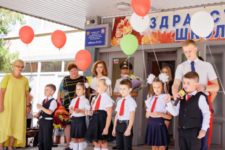 Kerch Russia - September 1, 2020 - children go to school, first bell, childrens in school uniforms, teachers and parents in the background near the schoolのeditorial素材