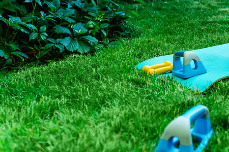 Yoga in garden with Yoga mat, asana summer timeの写真素材