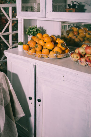Veranda of countryside house in autumn season. Autumn arbor, with yellow tree near it. ... Autumn picnic on the terraceの写真素材