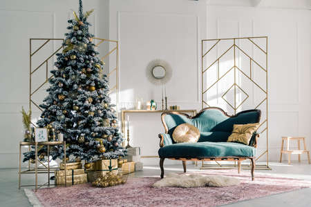 Beautiful holdiay decorated room with Christmas tree with presents under it