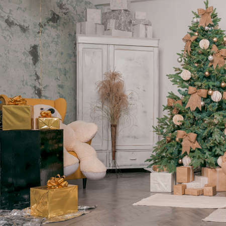 Beautiful holdiay decorated room with Christmas tree with presents under it