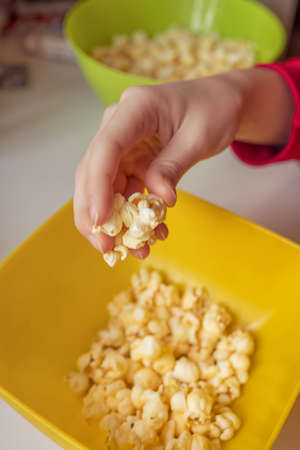 A bucket of popcorn, top-view, warm colors, daylight macro close-up, good timeの写真素材