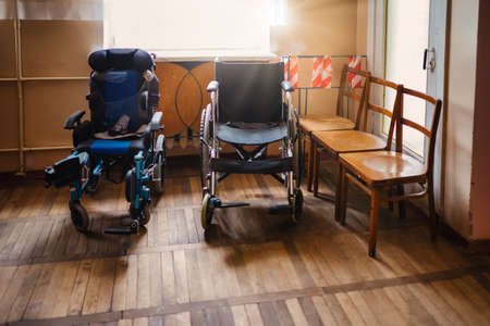 Empty wheelchair parked in hospital hallway, wheelchairs hospitalの写真素材