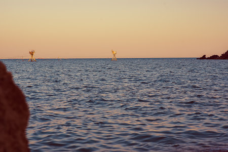 fishing nets in the sea, Soft wave of the sea on the sandy beach, summer vacation timeの写真素材